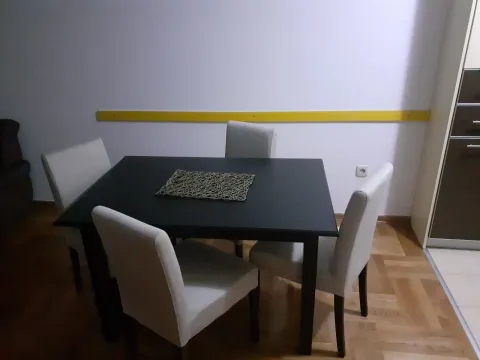 A dining table with four chairs. - image 3