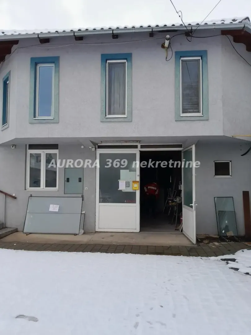 Exterior view of the house with an entrance door and a snow-covered yard.
