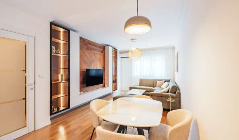 Modern living room with dining area and built-in units. - image 3