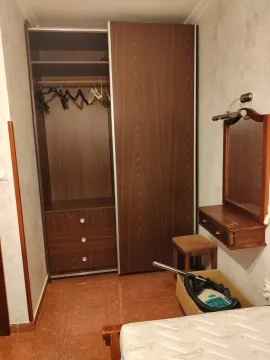 Bedroom with a large wardrobe and a mirror. - image 15