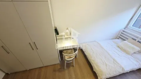 Small bedroom with a bed, wardrobe, and desk. - image 6