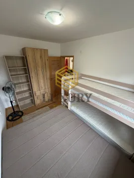 Children's bedroom with a bunk bed, wardrobe, and shelving unit. - image 7