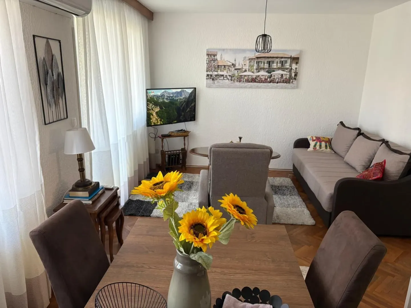 Bright living room with a dining table and a seating area.