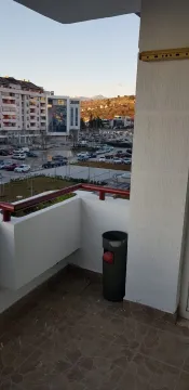 View from the balcony overlooking the urban neighborhood and parking area. - image 3