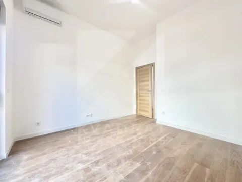 Empty bright room with wooden flooring and an air conditioning unit. - image 4