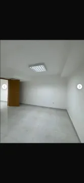 Empty bright room with tiled flooring and white walls. - image 11