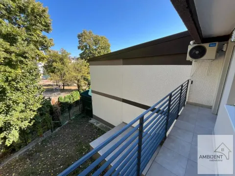 View from the balcony towards the yard and surrounding greenery. - image 16