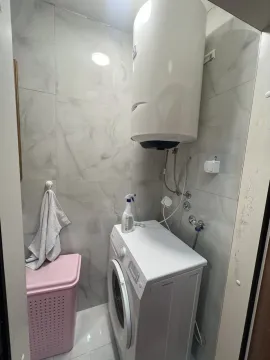 Part of the bathroom with a washing machine and water heater. - image 9