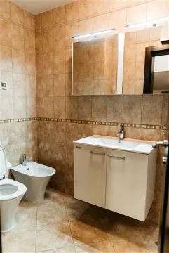 A bathroom featuring a bidet, a sink vanity, and a mirror cabinet. - image 24