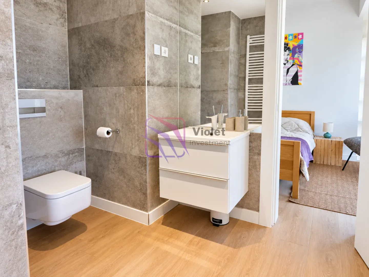 Modern bathroom with a view into the bedroom.