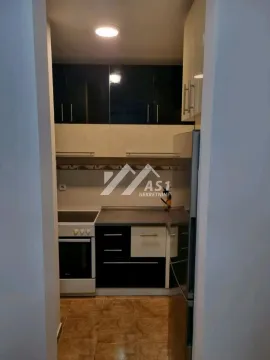 Smaller kitchen with cabinetry and built-in appliances. - image 7