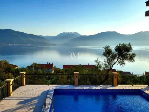 View of the sea and mountains from a terrace with a swimming pool. - image 3