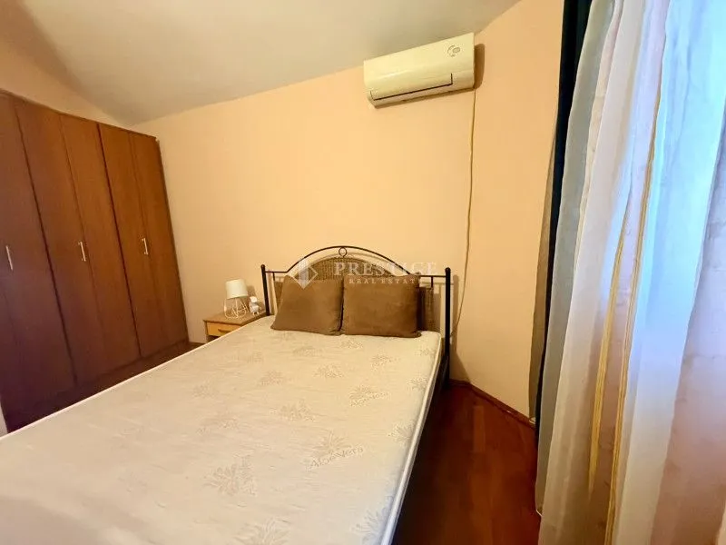 Furnished bedroom with a double bed, wardrobe, and air conditioning.