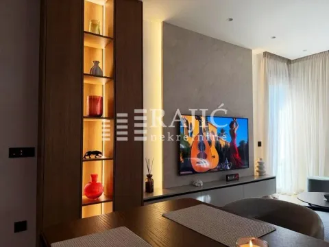 Living room with modern furniture, television, and decorative lighting. - image 8