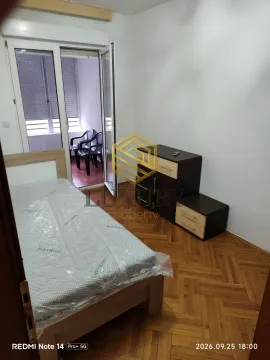 Furnished bedroom with a bed, dresser, and access to the terrace. - image 6