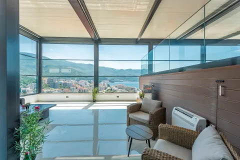 Enclosed terrace with seating and a panoramic view of the sea. - image 4
