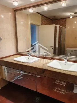 Bathroom with a large mirror, double sinks, and vanity cabinet. - image 13
