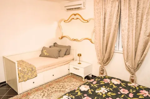 Furnished bedroom with a bed and a window with curtains. - image 11