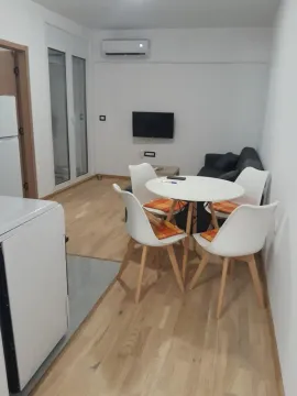 Living room with a dining table and chairs. - image 4