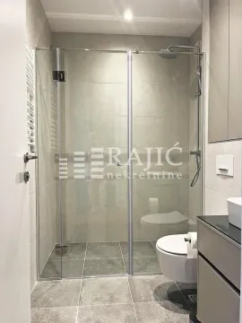 Modern bathroom with a walk-in shower and sanitary fixtures. - image 4