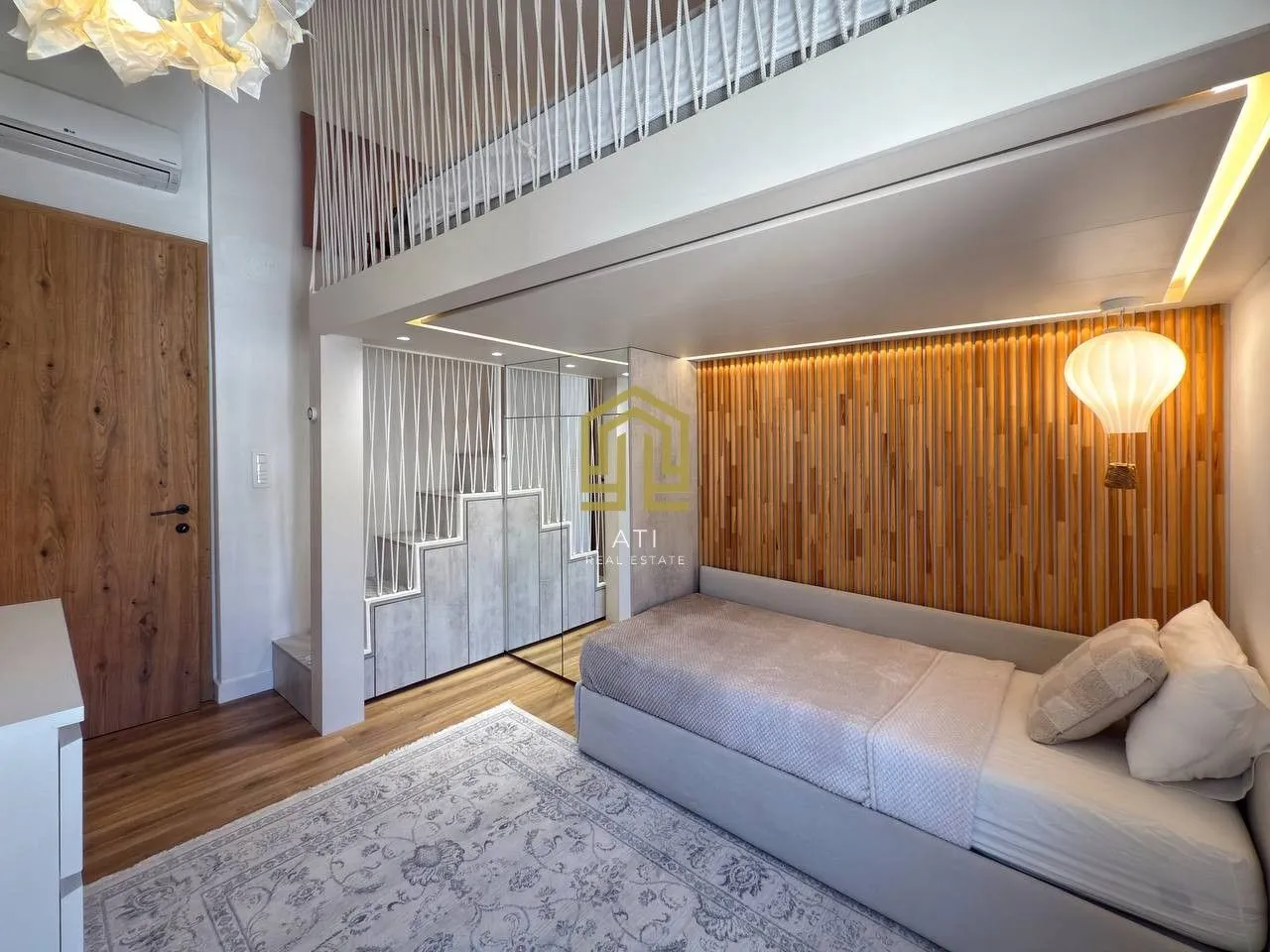 Modern bedroom with a bed and a gallery.