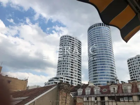 View from the terrace overlooking city buildings and skyscrapers. - image 13