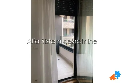 View through the balcony door to the terrace and surrounding buildings. - image 13