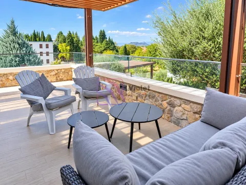 Spacious covered terrace with seating furniture and a view of greenery. - image 2