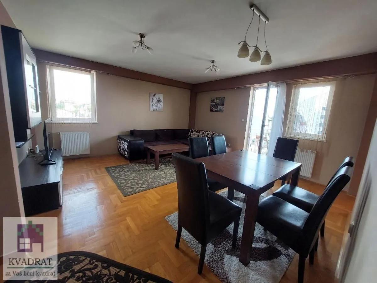 Spacious living room with a dining area and seating set.