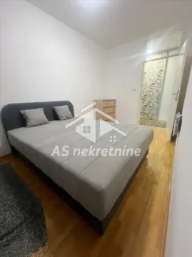 Bedroom with a double bed and wooden flooring. - image 12