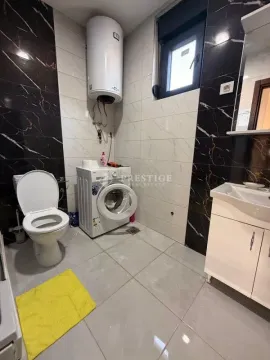Modernly equipped bathroom with a washing machine and water heater. - image 9