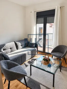Living room with a grey sofa, armchairs, and a glass coffee table, with access to the terrace. - image 2