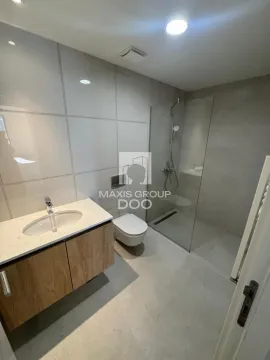 Modernly equipped bathroom with a walk-in shower, washbasin, and toilet. - image 14