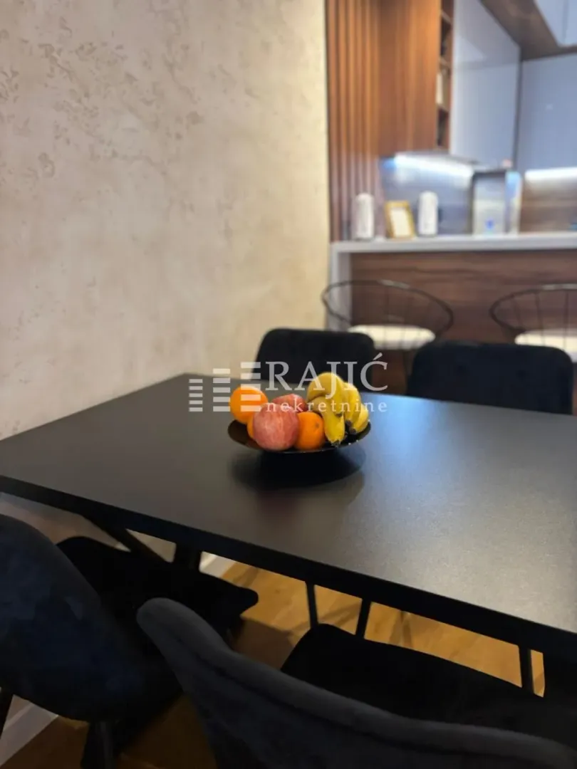Dining table with a bowl of fruit in a modern interior.