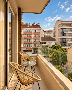 Furnished balcony with seating set and city view. - image 10