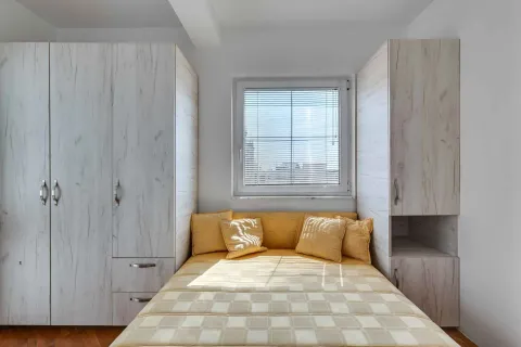 Bedroom with a double bed and built-in wardrobes. - image 19