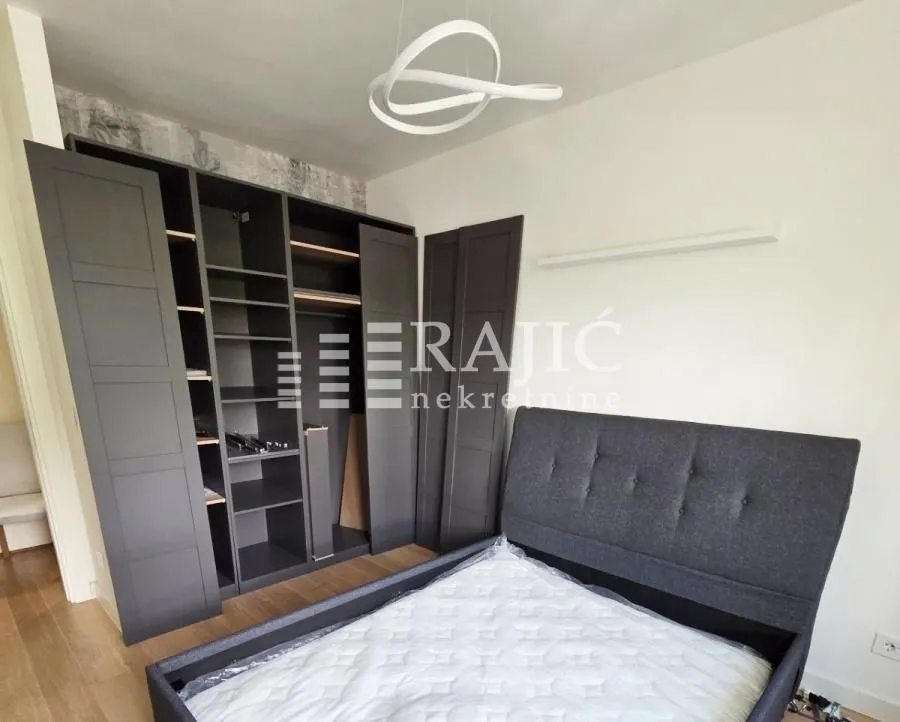 Furnished bedroom with a double bed and wardrobe.
