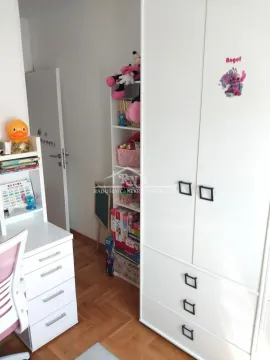 Children's room with a white wardrobe, desk, and toy shelves. - image 9