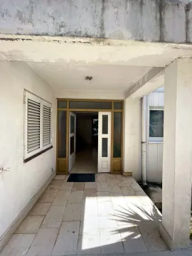 Main entrance to the house with a covered porch and open double doors. - image 4