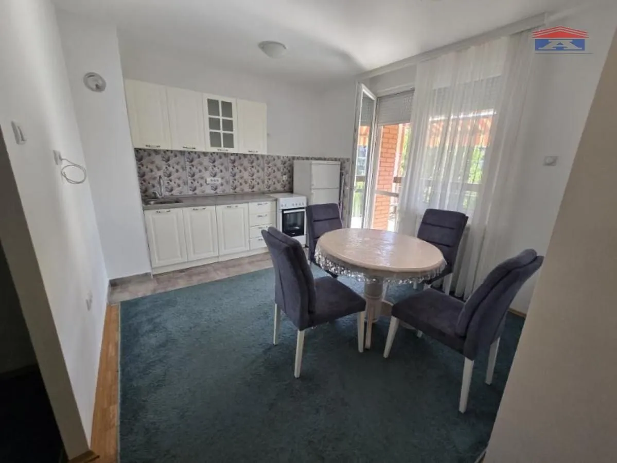 Kitchen with dining area and access to the terrace.