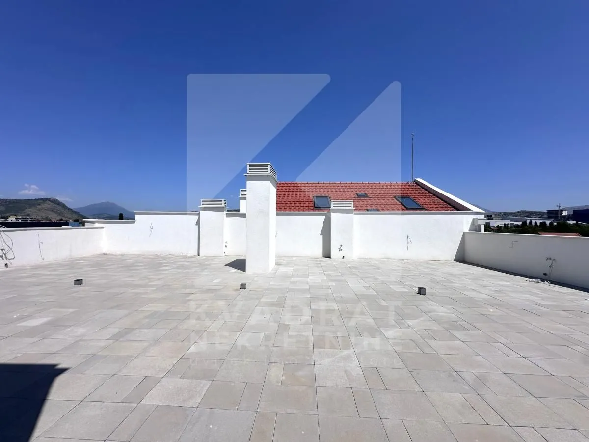 Large tiled roof terrace with surrounding views.