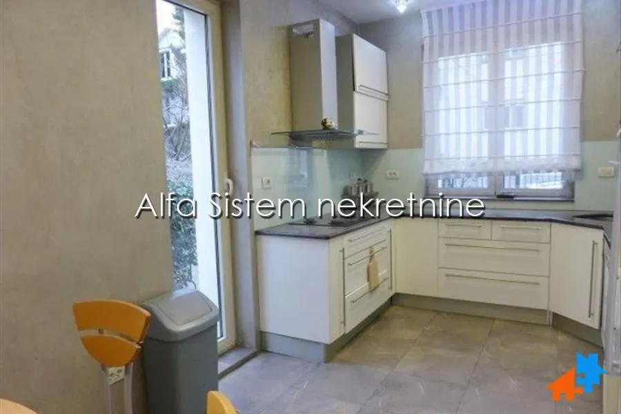 Kitchen with white cabinetry and access to the terrace.