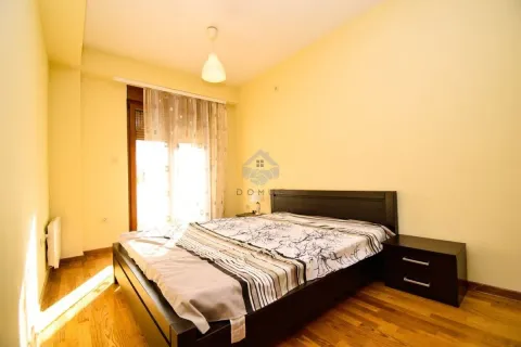 Bedroom with a double bed, nightstand, and a window with curtains. - image 7