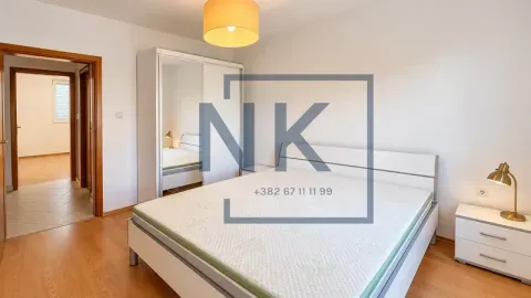 Furnished bedroom with a double bed, wardrobe, and nightstand. - image 9