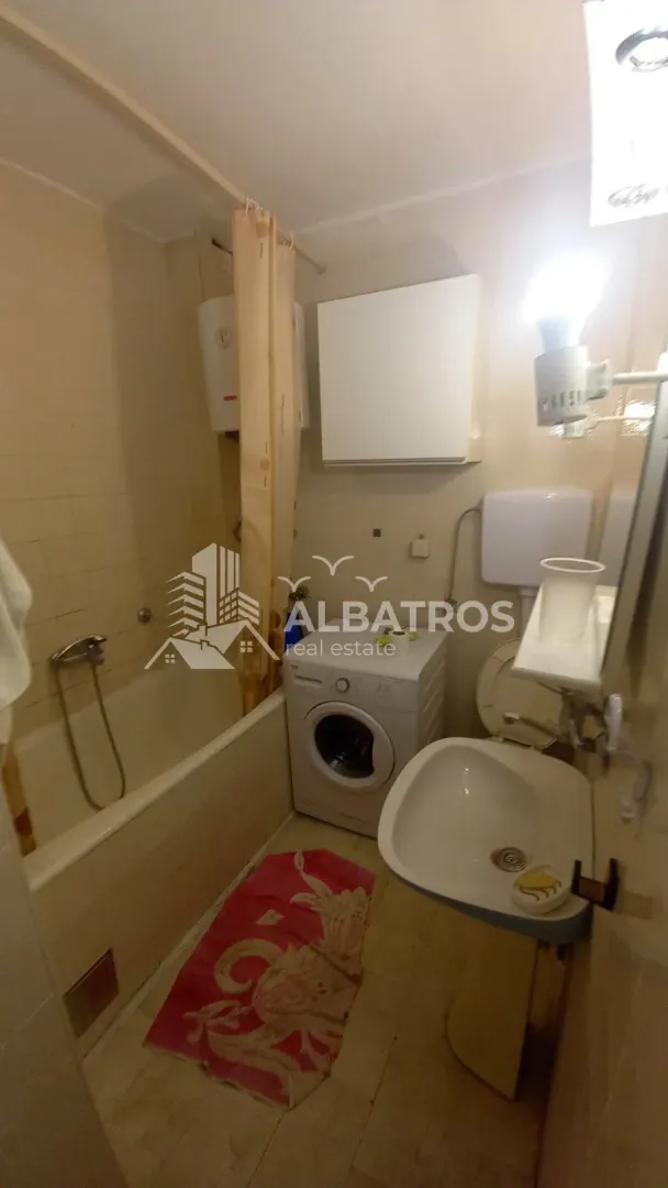 Bathroom equipped with a bathtub, washbasin, toilet, and washing machine.