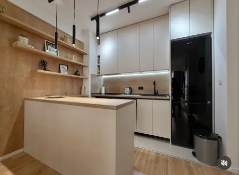 Modern kitchen with a breakfast bar and wooden wall panels. - image 5