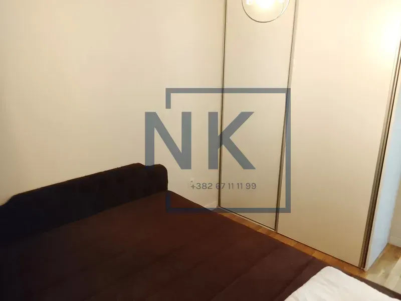 Bedroom with a double bed and a fitted wardrobe.