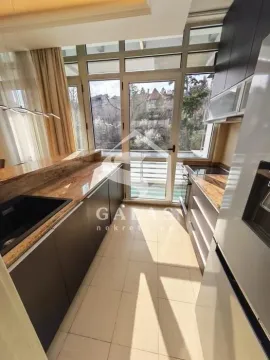 Modern kitchen with access to the terrace and large glass surfaces. - image 6
