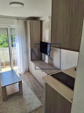 Smaller living room with kitchen and terrace access. - image 4