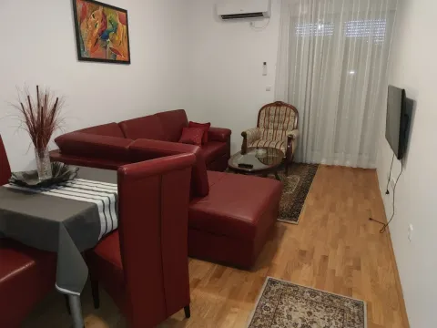 Living room with a red sofa. - image 4